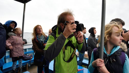 A family on a boat sailing to the Farne Islands